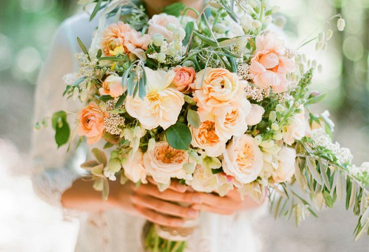 a subtle peachy and white wedding bouquet with greenery is a cool idea for a spring wedding