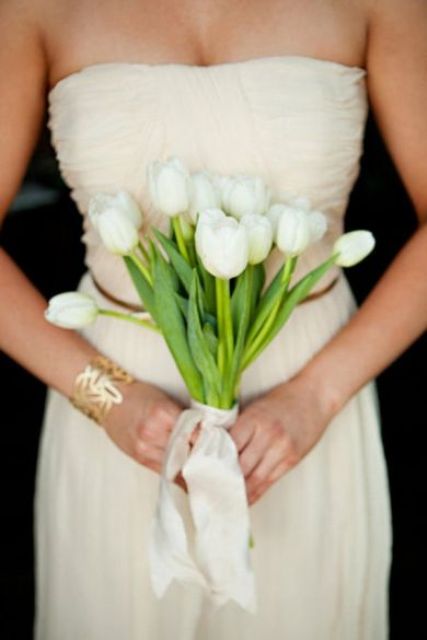 a romantic white tulip wedding bouquet with white bows is a cool and classic idea for a spring bride
