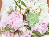a spring wedding bouquet with light pink and white blooms and greenery is a season-embracing one