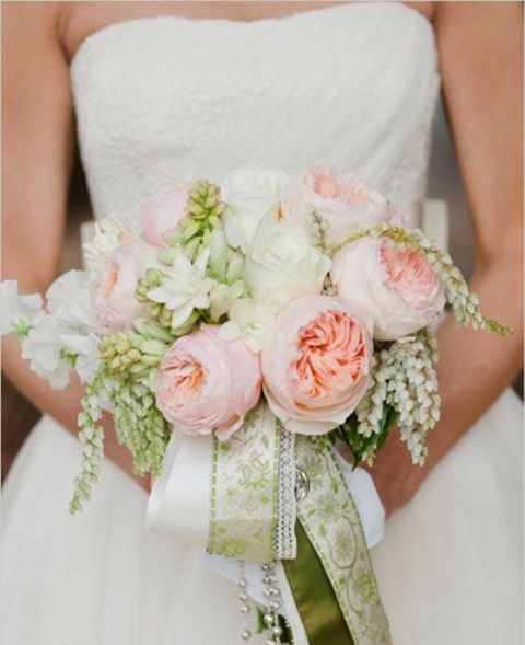 a romantic spring wedding bouquet with blush peonies, white blooms and green ribbons for spring