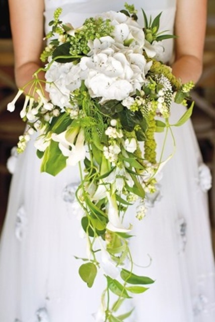 a crazy textural spring wedding bouquet with white blooms and greenery is a bold idea with much interest