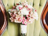 a simple spring wedding bouquet with pink and white blooms plus a simple white wrap for a spring bride