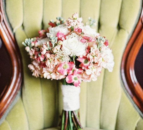 a simple spring wedding bouquet with pink and white blooms plus a simple white wrap for a spring bride