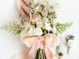 a dreamy spring wedding bouquet with blush and white blooms, greenery and white foliage