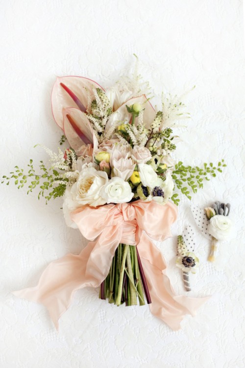 a dreamy spring wedding bouquet with blush and white blooms, greenery and white foliage