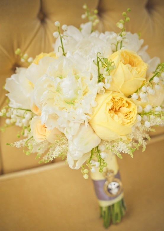 a pastel spring wedding bouquet in ivory and soft yellows plus lily of the valley and a simple wrap
