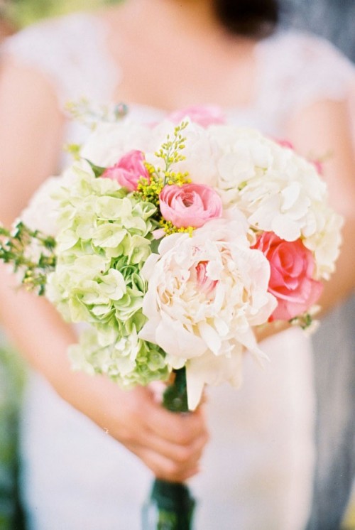 a cute spring wedding bouquet with blush, pink and greenery blooms is ideal for a spring bride