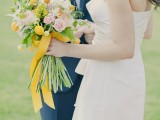 a romantic spring wedding bouquet of blush peonies and craspedia plus yellow ribbons