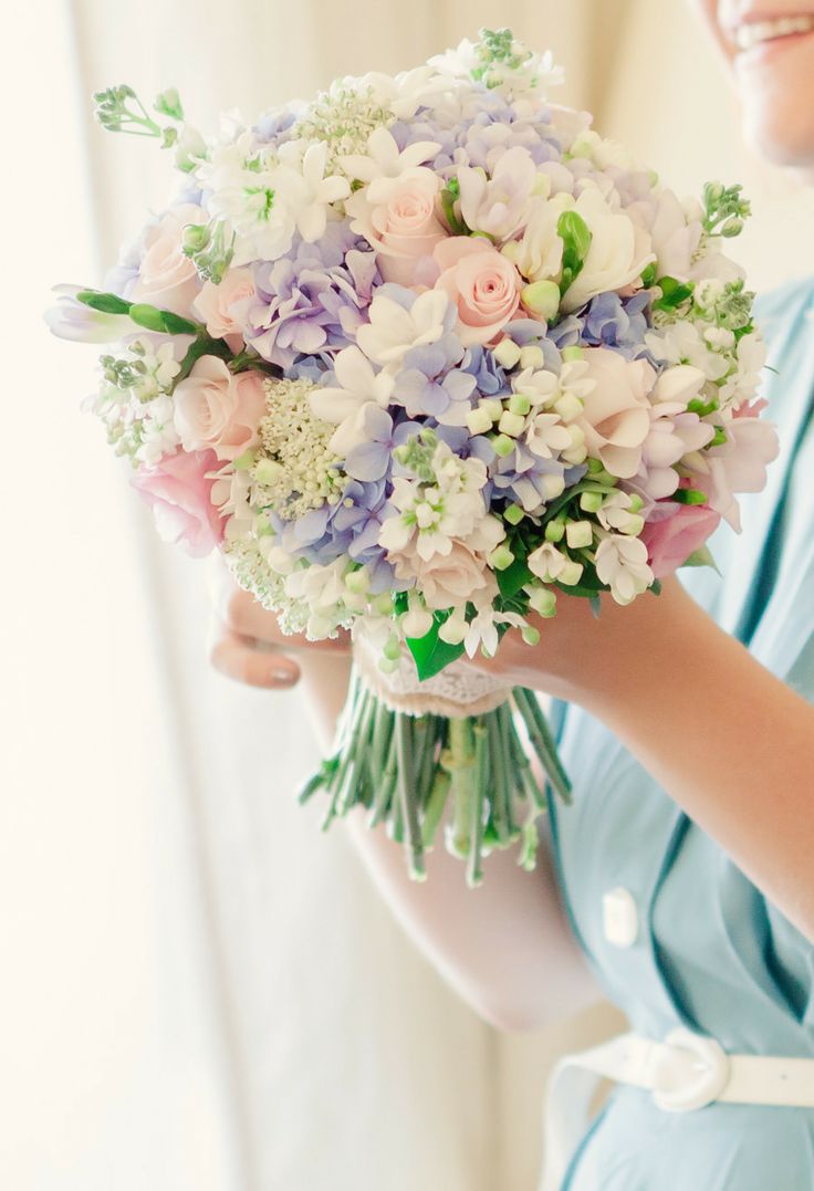 a pastel spring wedding bouquet with lilac, blush, green and light pink flowers for a spring bride
