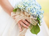 a blue hydrangea wedding bouquet with mesh ribbons for a slight rustic touch in your bridal style