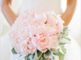 a light pink peony wedding bouquet with pale greenery is a stylish and cute idea for a spring bride
