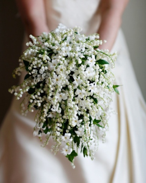 a gorgeous white lily of the valley wedding bouquet with a cascadign shape for a spring bride