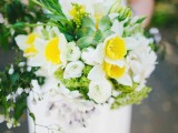 a white and yellow wedding bouquet with bold greenery and some succulents for a spring bride