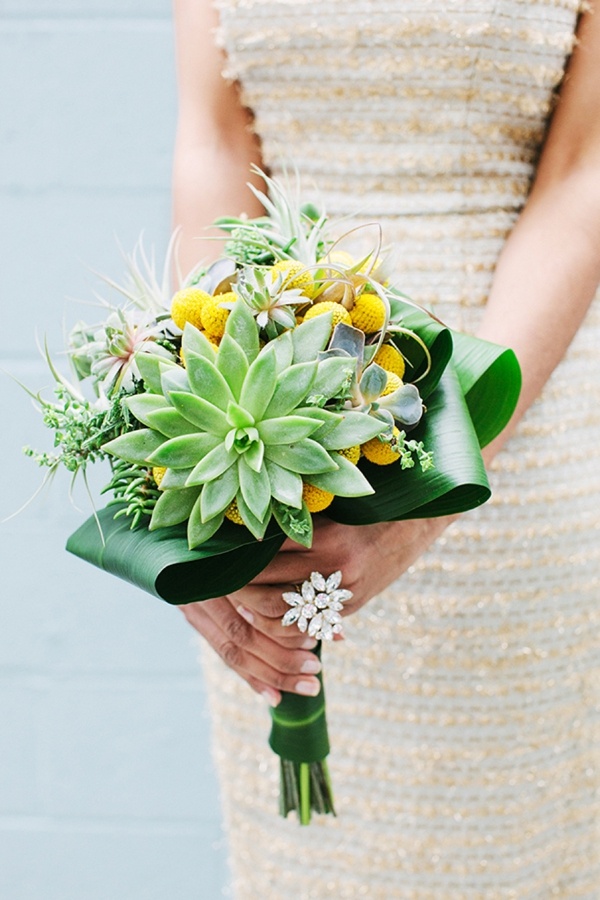 a bright spring wedding bouquet with succulents, air plants and craspedia for a bold bridal look