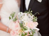 a chic pastel wedding bouquet with light pink and white blooms and some touches of greenery