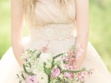 a romantic wedding bouquet of white and light pink blooms, with plenty of texture and greenery