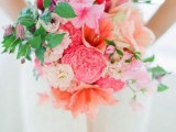 a colorful wedding bouquet in hot pink and red plus greenery is a cool idea for a sprign color-loving bride