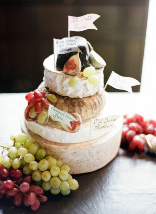 if your groom doesn't like sweets, go for a cheese wheel stack topped with fresh fruit and berries