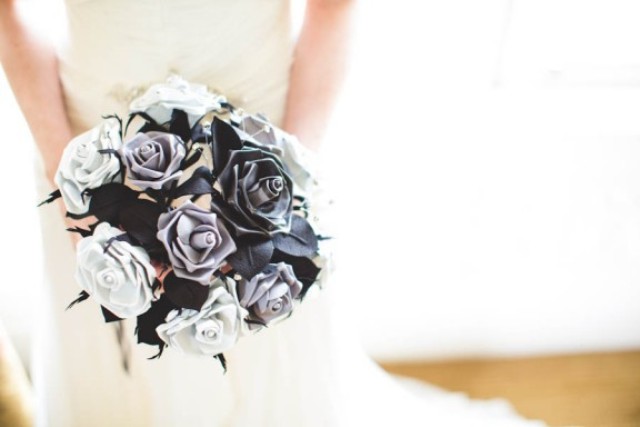 A black and white paper rose wedding bouquet is a bold and contrasting idea for a bride