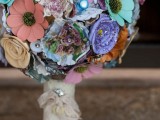 a colorful plastic flower wedding bouquet with buttons and rhinestones, with a lace wrap is a fun and bright idea to rock