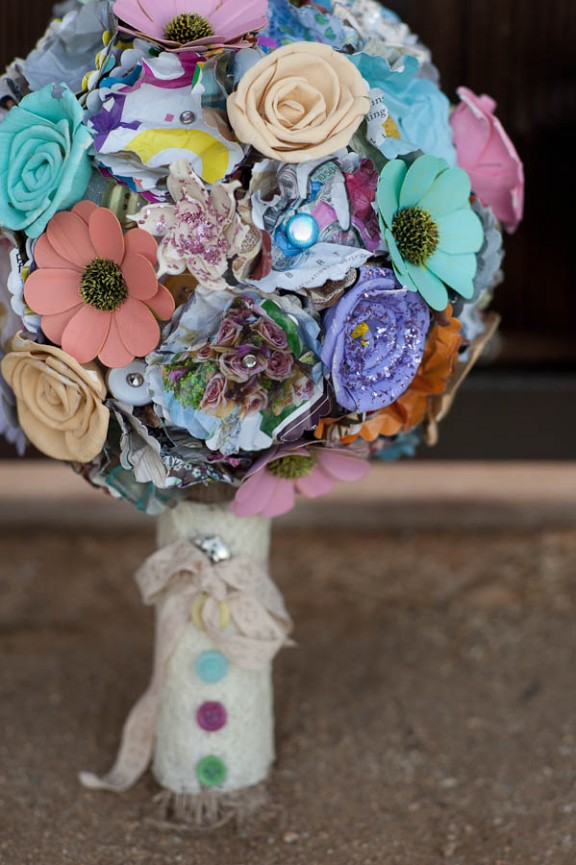 A colorful plastic flower wedding bouquet with buttons and rhinestones, with a lace wrap is a fun and bright idea to rock