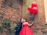 several red balloons instead of a traditional wedding bouquet are a fun and cool idea for a playful bride