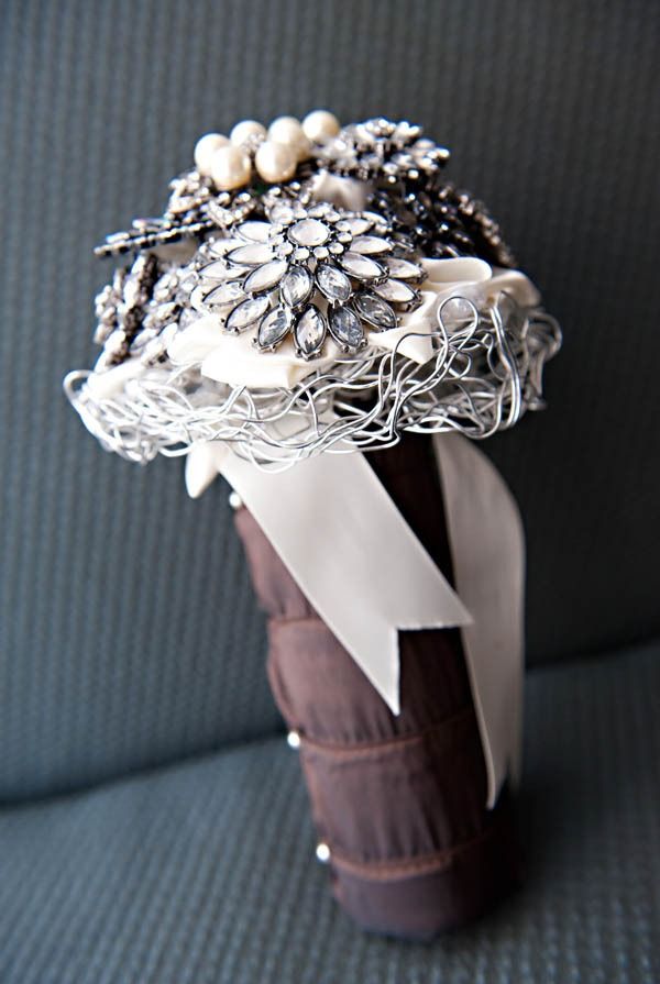 A refined neutral rhinestone and pearl brooch wedding bouquet with some wire, with a fabric wrap and ribbons is a lovely idea