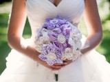 a pretty purple plaid and white fabric flower wedding bouquet with buttons and burlap is a fun idea for a summer bride