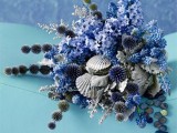 a coastal wedding bouquet of allium, blue flowers and seashells is an amazing idea for a coastal bride