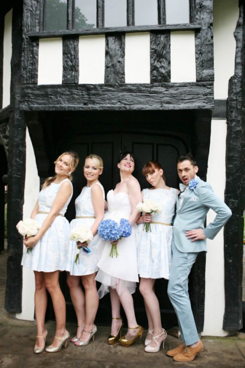 bridesmaids wearing over the knee white A-line dresses and a bridesman wearing a blue pantsuit - such pantsuits can be rocked by everyone