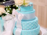 an elegant light blue wedding cake