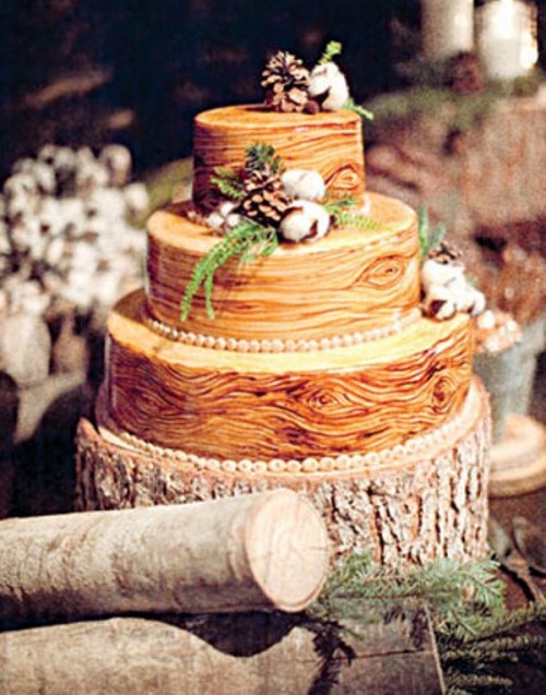 a bark-imitating wedding cake topped with pinecones, greenery and cotton pieces is a lovely idea for a rustic or woodland winter wedding