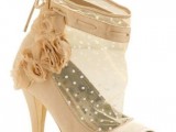 a semi sheer bridal peep toe bootie with polka dot detailing and fabric flowers on its side