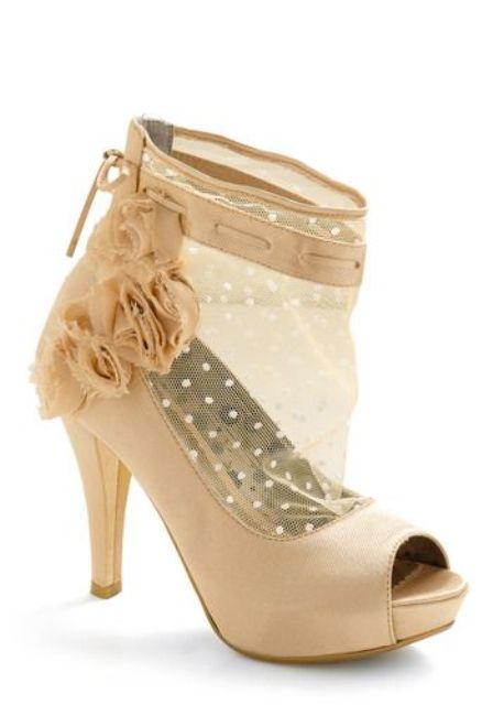 a semi sheer bridal peep toe bootie with polka dot detailing and fabric flowers on its side