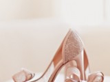 dusty pink peep toe wedding shoes with lace parts and large bows for a girlish and refined bride