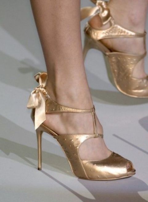 whimsy and shiny gold cutout shoes with bows on the backs are nice for a spring or a fall wedding or for brides who love glam