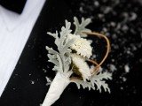 a pale boutonniere of white blooms and pale leaves for accessorizing a classic and chic groom’s look