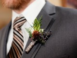 a white bloom, a pinecone, berries and greenery for accessorizing a winter groom’s look and make it chic
