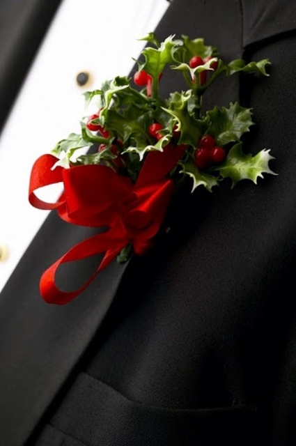 a lush Christmas boutonniere of red berries, leaves and a red ribbon bow is a bold and cool accessory to try