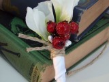 a white flower boutonniere with red berries and twine is a stylish accessory to go for and it’s easy to make