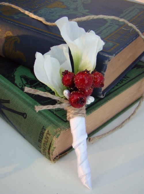 a white flower boutonniere with red berries and twine is a stylish accessory to go for and it's easy to make