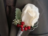 a white rose, pale leaves, berries boutonniere is a cute accessory for a winter groom