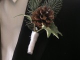 a sparkling winter boutonniere of leaves, a pinecone and fir with ribbon wrapping is a cute and chic accessory to rock