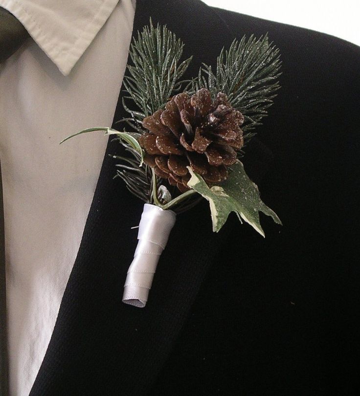 A sparkling winter boutonniere of leaves, a pinecone and fir with ribbon wrapping is a cute and chic accessory to rock