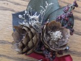 a rough winter boutonniere with pinecones, leaves, berries and dried herbs is a great accessory for a winter groom
