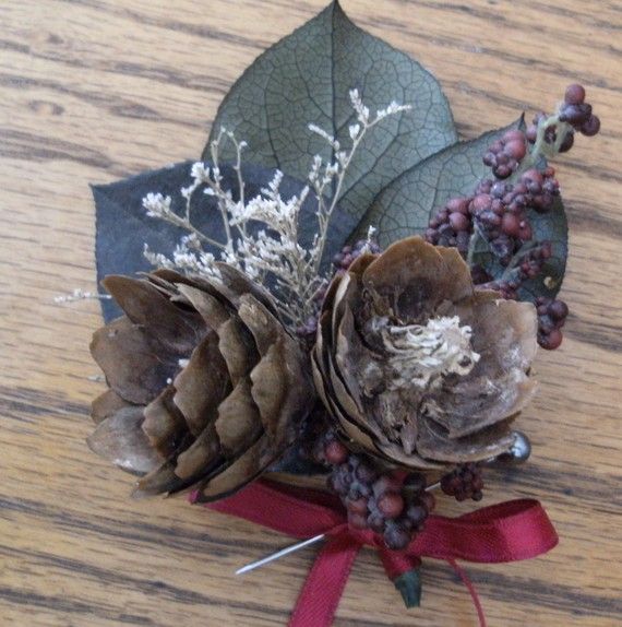 A rough winter boutonniere with pinecones, leaves, berries and dried herbs is a great accessory for a winter groom