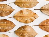 dried amber leaves as escort cards are an easy and budget-friendly idea for a fall wedding