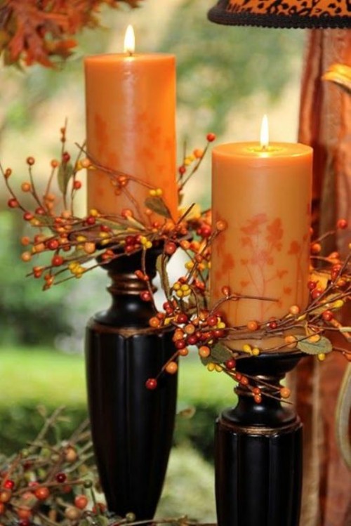 rust-colored candles covered with leaves and berries are great for decorating your fall wedding