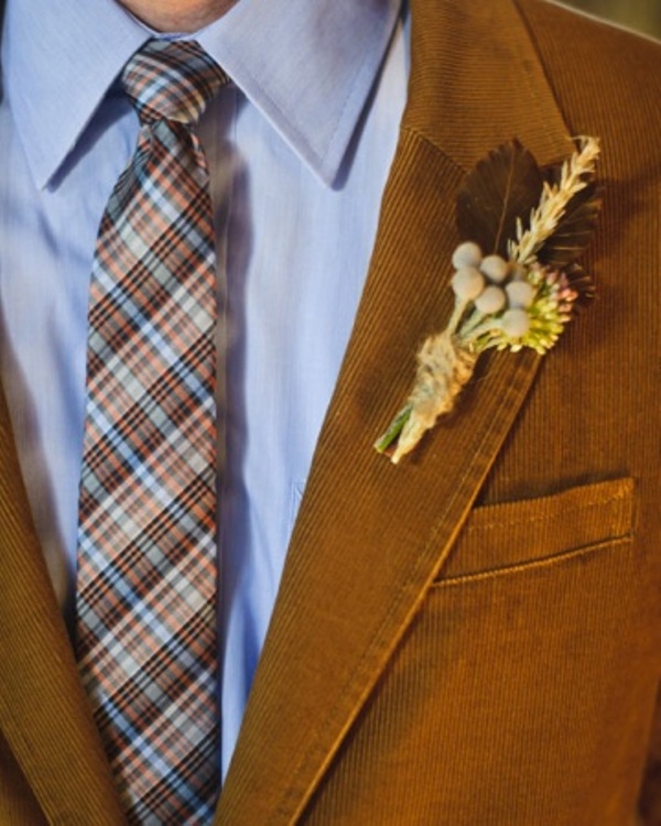 A rust colored velvet blazer and a bright plaid tie for a stylish fall groom look