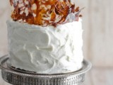 a white buttercream wedding cake with amber caramel shards on top is a very creative and cool idea for a modern fall wedding